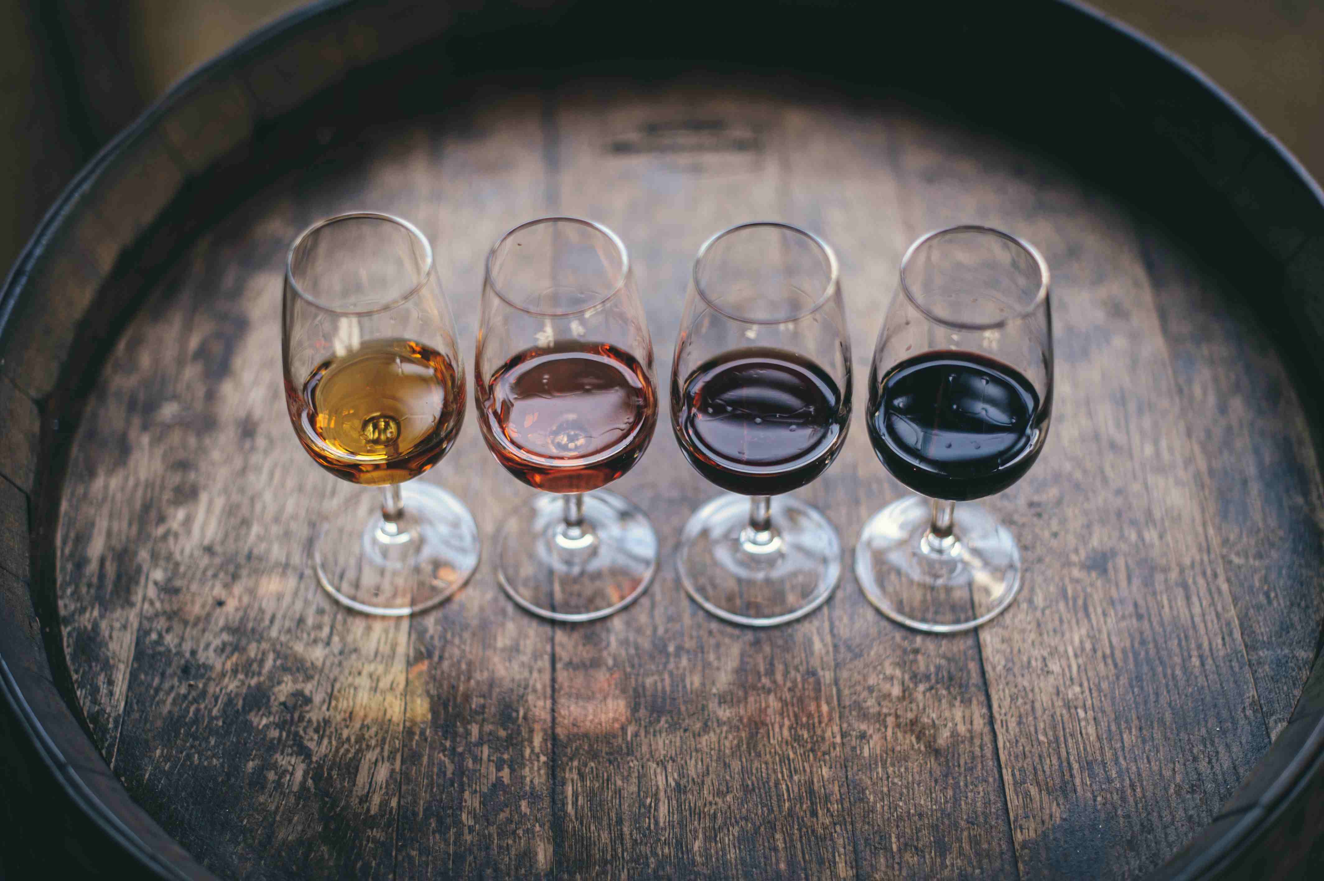 Row of wine glasses lined up for a blind tasting on a white table