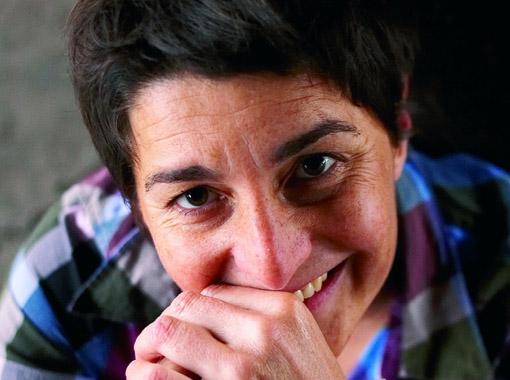 Close-up portrait of Isabelle Legeron in a chequered shirt