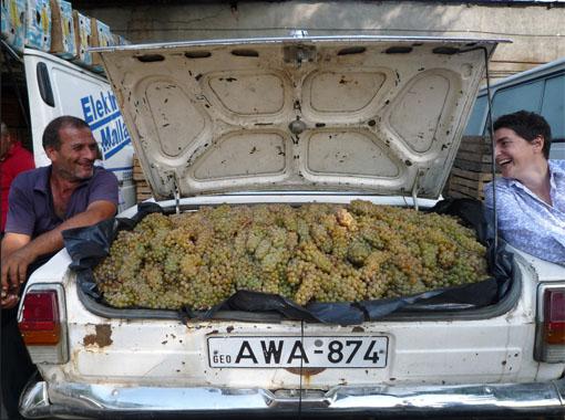 Isabelle Legeron at a grape bazaar with a car boot full of grapes in Georgia
