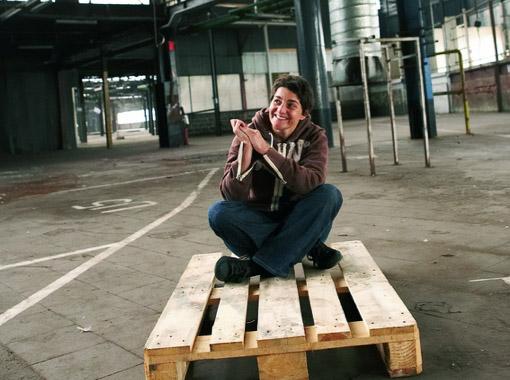 Isabelle Legeron sitting on a wine pallet