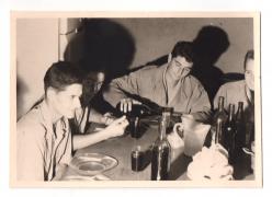 Vintage black and white photograph of Pierre Legeron pouring wine for his friends